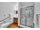 Bathroom with wood floor, grab bars, glass shower door, and white vanity at 5453 Happy Hollow # 73, Indianapolis, IN 46268
