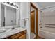 Bathroom featuring wood vanity, mirror, and combination shower and tub at 5453 Happy Hollow # 73, Indianapolis, IN 46268
