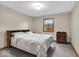 Bedroom with gray carpet and comforter, window, and wood trim at 5453 Happy Hollow # 73, Indianapolis, IN 46268
