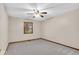 Bright bedroom featuring neutral walls, ceiling fan, window, and carpeted floor at 5453 Happy Hollow # 73, Indianapolis, IN 46268