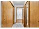 Hallway featuring wood trim doors and closet, plus view of bathroom at 5453 Happy Hollow # 73, Indianapolis, IN 46268