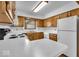 Bright kitchen with wooden cabinets and white countertops at 5453 Happy Hollow # 73, Indianapolis, IN 46268