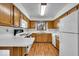 Well-lit kitchen with wooden cabinets and white countertops at 5453 Happy Hollow # 73, Indianapolis, IN 46268