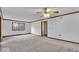 Airy living room featuring neutral carpet, a fan, and wooden trim accents at 5453 Happy Hollow # 73, Indianapolis, IN 46268