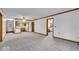 Open living area with neutral carpet seamlessly connecting to the kitchen and other rooms at 5453 Happy Hollow # 73, Indianapolis, IN 46268