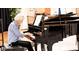 Resident playing piano at community at 5453 Happy Hollow # 73, Indianapolis, IN 46268