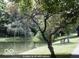 A tranquil community pond with seating along the edge; a beautiful and serene spot to relax and enjoy nature at 5453 Happy Hollow # 73, Indianapolis, IN 46268