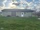 Backyard with detached garage, fresh lawn, and mature trees at , Indianapolis, IN 46203