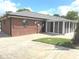 Back of the house features a screened-in porch and large brick patio at , Indianapolis, IN 46203