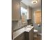 Charming bathroom with gray walls featuring a granite countertop, cabinets, framed mirror and a window shade at , Indianapolis, IN 46203
