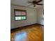 Inviting bedroom featuring hardwood floors, a ceiling fan, and a window with natural light at , Indianapolis, IN 46203