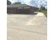 Long concrete driveway leading to a brick home with an attached garage and detached garage at , Indianapolis, IN 46203