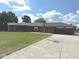 Well-maintained brick home featuring an attached garage, basketball hoop and long concrete driveway, offering ample parking at , Indianapolis, IN 46203