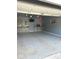 Spacious garage interior featuring an epoxy floor, work bench, TV and custom cabinetry at , Indianapolis, IN 46203