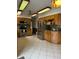 Well-equipped kitchen featuring stainless steel appliances, wooden cabinets, and tiled flooring at , Indianapolis, IN 46203