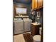 Well-lit laundry room features both washer and dryer with storage cabinets and vanity at , Indianapolis, IN 46203