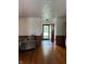 Bright and airy living room with hardwood floors and a glimpse of the front yard through the door at , Indianapolis, IN 46203