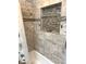 Modern bathroom tiled shower and tub featuring sleek hardware, a convenient shower niche and decorative shower curtain at , Indianapolis, IN 46203