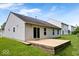Home's back exterior with a spacious wooden deck, ideal for outdoor relaxation and entertainment at 5842 Minden Dr, Indianapolis, IN 46221
