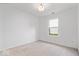 Bright bedroom featuring neutral carpet, white walls, and a window with natural light at 5842 Minden Dr, Indianapolis, IN 46221
