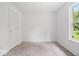 Standard bedroom with door, carpet and window to the back yard at 5842 Minden Dr, Indianapolis, IN 46221