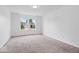 Bright, carpeted bedroom with a view of the neighborhood through the window at 5842 Minden Dr, Indianapolis, IN 46221