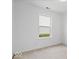 Well-lit bedroom with a window, neutral carpet, and white walls at 5842 Minden Dr, Indianapolis, IN 46221