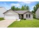 Charming single-story home featuring a brick facade, attached garage, and well-manicured lawn at 5842 Minden Dr, Indianapolis, IN 46221