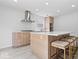 Modern kitchen features a center island with seating and stainless steel hood at 5842 Minden Dr, Indianapolis, IN 46221