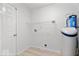 Functional laundry room equipped with water softener and shelving, optimizing organization and convenience at 5842 Minden Dr, Indianapolis, IN 46221