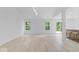 Bright, open living room featuring modern light fixtures, light wood floors, and view of the yard at 5842 Minden Dr, Indianapolis, IN 46221