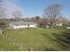 The large backyard is shown in an aerial view, complete with trees and green grass at 589 S 100 W, Franklin, IN 46131
