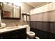 Comfortable bathroom with dark wood vanity, large mirror, and shower with patterned curtain at 589 S 100 W, Franklin, IN 46131
