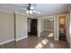 Neutral bedroom with fan and adjoining bathroom with mirrored closet at 589 S 100 W, Franklin, IN 46131