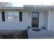 A view of the front entrance, complete with a black storm door and space for plants on the stoop at 589 S 100 W, Franklin, IN 46131