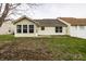 Back exterior featuring a patio, lawn and view of a neighboring house with vinyl siding at 6145 Crystal View Dr, Indianapolis, IN 46237