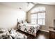 Cozy bedroom with a vaulted ceiling, a large window, wood floors, and a floral bedspread at 6145 Crystal View Dr, Indianapolis, IN 46237