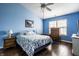 A blue bedroom is furnished with nightstands and a dresser and has hardwood floors at 6145 Crystal View Dr, Indianapolis, IN 46237