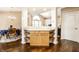 A dining room with hardwood floors featuring a blue tablecloth and a cabinet with open shelving and storage at 6145 Crystal View Dr, Indianapolis, IN 46237