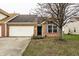Charming single-Gathering home featuring a brick facade, attached garage and well-maintained landscaping at 6145 Crystal View Dr, Indianapolis, IN 46237