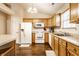 A functional kitchen with wooden cabinets, white appliances, and hardwood floors presents a clean and practical design at 6145 Crystal View Dr, Indianapolis, IN 46237