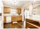 A kitchen featuring wooden cabinets, a stainless steel sink and modern appliances with hardwood floors at 6145 Crystal View Dr, Indianapolis, IN 46237
