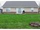 The backyard is fenced in and features a grassy lawn and patio with brick and siding exterior at 6418 W Oxford Ln, McCordsville, IN 46055