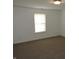 A bright carpeted bedroom features a window with blinds for natural light and is freshly painted at 6418 W Oxford Ln, McCordsville, IN 46055