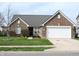 Charming single-story brick home with well-manicured lawn and attached two car garage at 6418 W Oxford Ln, McCordsville, IN 46055