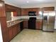 Well-equipped kitchen with stainless steel refrigerator and black appliances at 6418 W Oxford Ln, McCordsville, IN 46055