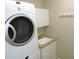 Laundry room with stacked washer and dryer and cabinet-lined wash basin at 6418 W Oxford Ln, McCordsville, IN 46055