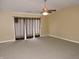 Spacious living room featuring a ceiling fan and sliding glass doors at 6418 W Oxford Ln, McCordsville, IN 46055