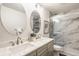 Bright bathroom featuring a dual vanity with marble countertop and an elegant glass-enclosed shower at 6733 Dorchester Dr, Zionsville, IN 46077