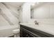 Well-lit bathroom featuring a modern vanity and a shower with elegant marble-style tile at 6733 Dorchester Dr, Zionsville, IN 46077